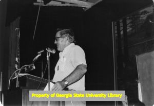 Herb Green speaking behind a podium