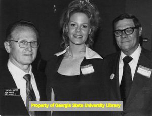 Georgia State Senator Bethel Salter, Miss Atlanta, Gayle Nelson, and her father Lewis Nelson at a legislative reception, Atlanta, Georgia, February 1974.