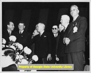 President Harry Truman, Adlai Stevenson, and others on stage.