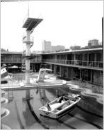 Speedboat with woman in bathing suit, in the Heart of Atlanta Motel swimming pool. Image for an advertising campaing conducted by the Charles A. Rawson and Associates advertising and public relations firm, at the Heart of Atlanta Motel, Atlanta, Georgia, February 27, 1960.
