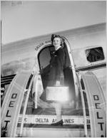 Coca-Cola Company commissioned photograph. This photo is of the stairs onto a Delta Airlines airplane, where a flight-attendant is holding a metal Coca-Cola cooler