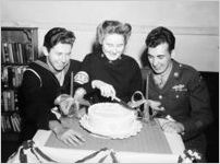Wounded soldiers and sailors celebrating with a cake at a USO Service Men's Center, Atlanta, Georgia, 1945.