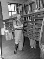 Man with a prosthetic leg working with a riveter, State Department of Education, Vocational Rehabilitation Division, Georgia, August 1942.