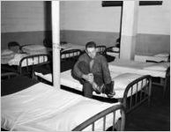 Soldier getting ready to take a nap in a USO Service Men's Center, Atlanta, Georgia, 1946.