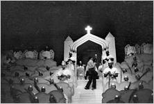 Photographer on stage, shooting a scene from the morality play "Heaven Bound," staged by the Big Bethel African Methodist Choir, at the Atlanta Theatre (23 Exchange Place), Atlanta, Georgia, August 1937