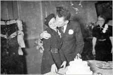 Newlyweds cutting their cake at a modest wedding ceremony, typical of the World World II era, Georgia, 1939