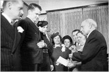 Justice of the Peace reading from a book, at a modest wedding ceremony at bride's home, typical of the World World II era, Georgia, 1939