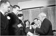 Justice of the Peace reading from a book, at a modest wedding ceremony at bride's home, typical of the World World II era, Georgia, 1939