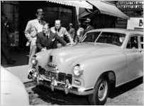 Abbott and Costello posing by a Kaiser-Frazer automobile