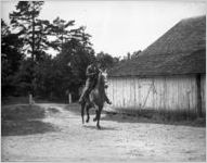 Horseman trotting through a barnyard, Georgia, 1926