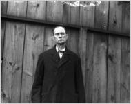 Man standing in front of a fence, Atlanta, Georgia.