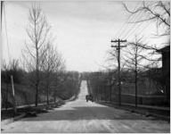 Wagon traveling down a road, 1926