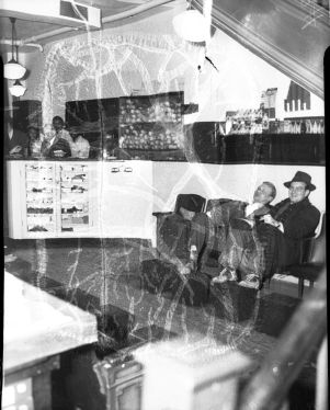 Customers waiting inside of a shoe maker store, 1940