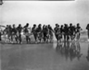 Group of men having a foot race on a beach, 1940s