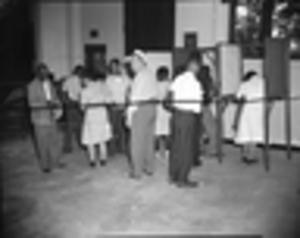 African Americans casting their vote in voting booths, 1946