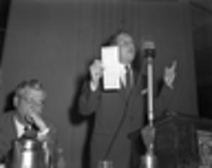 Man speaking and holding voting ballot during bond drive in Atlanta, 1946