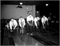 Group posing in bowling alley