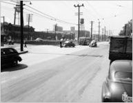 Railroad crossing with cars and bus