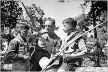 Boy Scouts,with Scout leader, honing a bow, Georgia, July 1937.