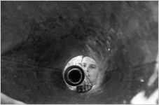 Looking down the inside of a megaphone at young boy playing trumpet, Georgia, July 1937.