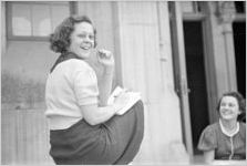 Agnes Scott College student sitting on steps to Buttrick Hall laughing,Decatur, Georgia, September 1937