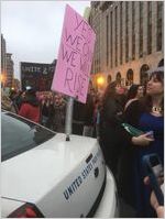 Yes We Can We Will Rise sign and police car, Women's March on Washington, 2017-01-21