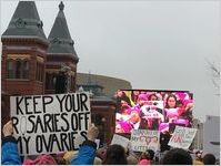 Protest signs in the crowd and on a television monitor, Women's March on Washington, 2017-01-21