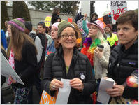 Close-up of protester smiling and wearing Nasty Woman sticker, Women's March on Washington, 2017-01-21