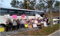Busload of protesters holding signs, Women's March on Washington, 2017-01-21