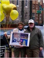 Carol and Joel Greenberg holding balloons and a protest sign, Women's March on Washington, 2017-01-21