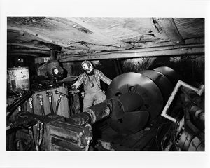 Auger bit, partially inserted into hole, of bi-direction auger in mine in Moundsville, West Virginia, circa 1970s