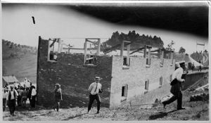 Men constructing brick buildings, circa 1910s