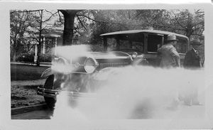 Van Bittner and other men standing at car, circa 1920s