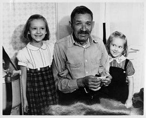 Father of Joe Gladski rolling a cigarette with his granddaughters, circa 1920s
