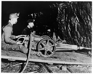 Miners operating a hydraulic drill, circa 1920s