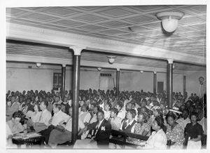 M. H. Ross (bottom left) taking notes during International Union of Mine, Mill, and Smelter Workers organizing meeting, circa 1940s