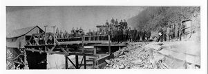Group photograph of miners with mine owner on bridge near tipple, circa 1890s