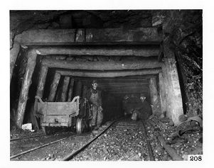 Coal miner next to empty coal car at bottom of Collier Mine shaft in Bartonville, Illinois, 1915