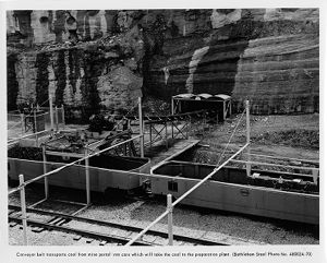 Conveyer belt transporting coal into cars headed to preparation plant, circa 1960s
