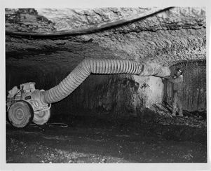 Flexible tubing installation in mine, circa 1960s