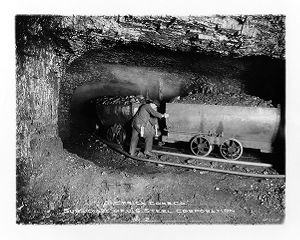 Coal miner coupling car on wide side, circa 1910s