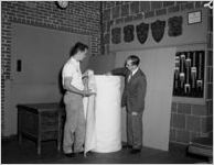 Examining a roll of Southern Mills fabric, 1963
