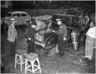 Police investigate the pickup truck where the body of Jeanette Reyman was found, 1947