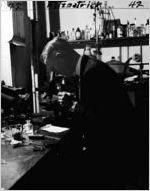 Dr. Herman Jones examines evidence in connection with the Peggy Refoule murder case. Here Dr. Jones is seen at the Fulton County Crime Lab in May 1947.