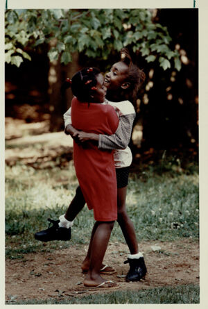 Rashaundra Jones hugs Cokithia Hilliard, May 30, 1990