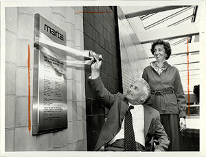 Clark Harrison Lifts Ribbon Monday as Liane Levetan Looks On, November 10, 1981