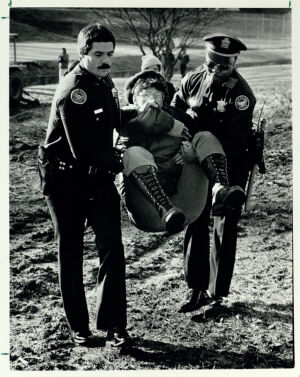 Atlanta police officers carry away Presidential Parkway protester Mary Newson, February 15, 1985