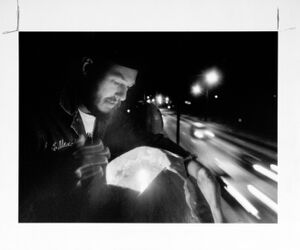 Richard Brough lights a pumpkin that reads "No Road"