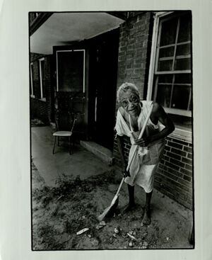 Atlanta Substandard Housing, Woman Sweeps Outside Her House in Poor Conditions, June 4, 1980