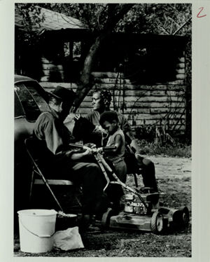 Atlanta Substandard Housing, Family Sits Outside Low Income Home Destroyed by Fire Caused by Faulty Wiring, November 17, 1985